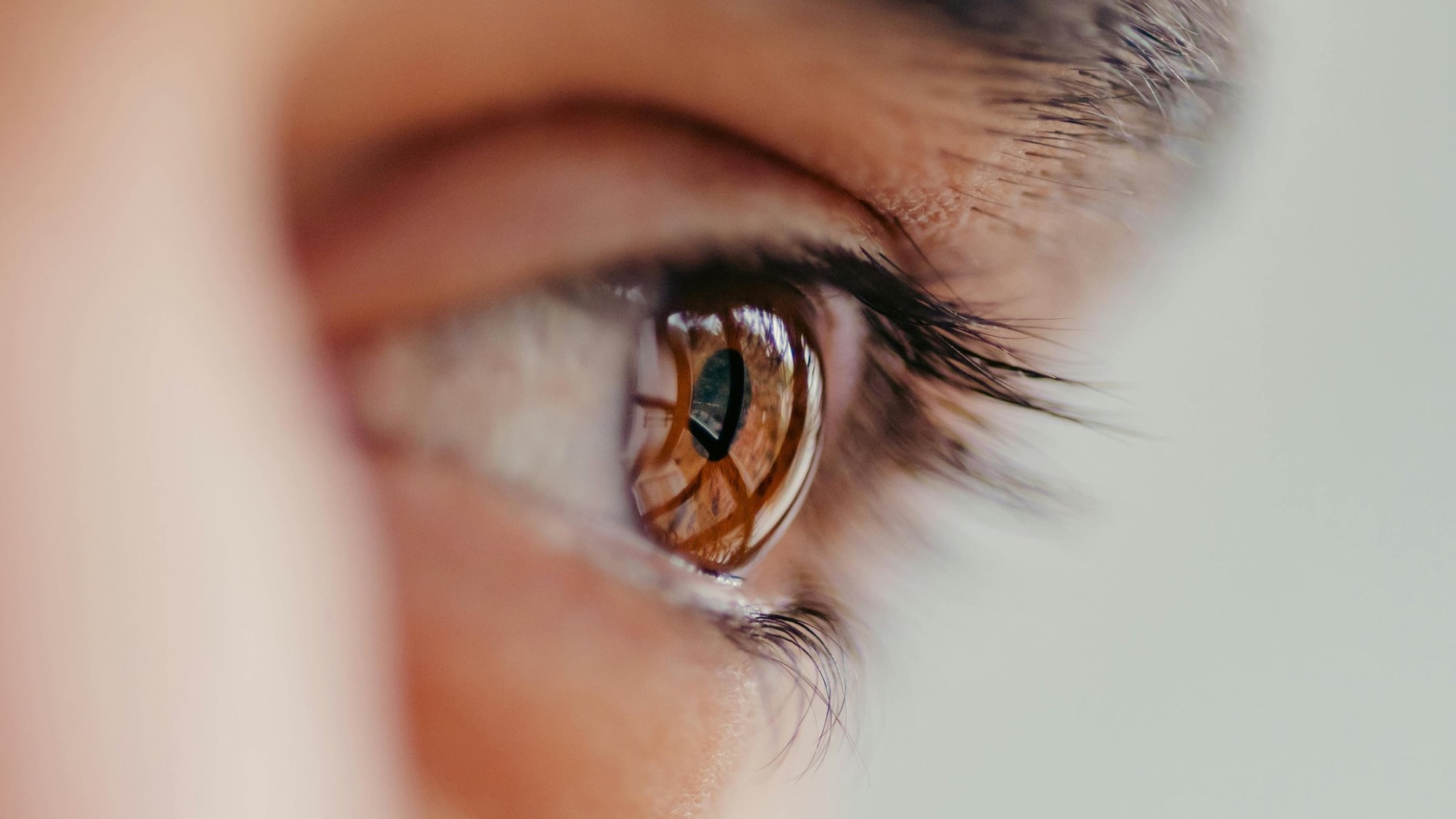 Close-up portrait of a woman's eyes in soft natural light, illustrating blepharoplasty eyelid surgery results